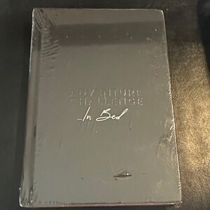 Adventure Challenge Book in bed, black book activity sealed